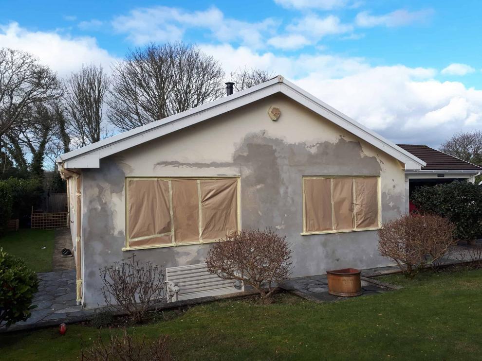 Front of truro bungalow in masking and repaired