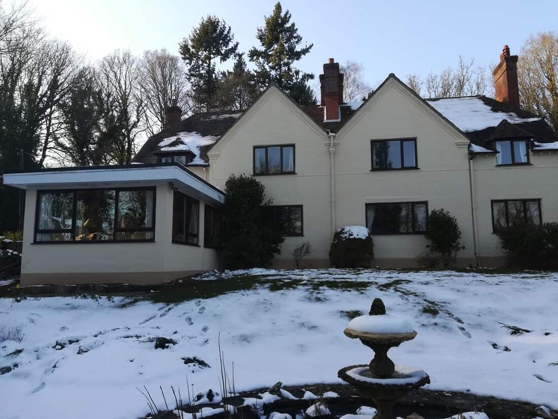 back of house after painting, with snow