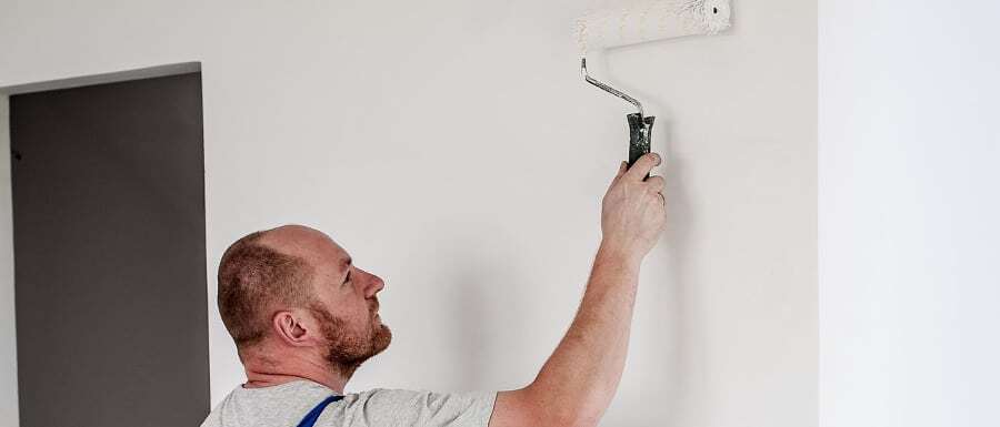 semi professional painter using trade paint on a wall