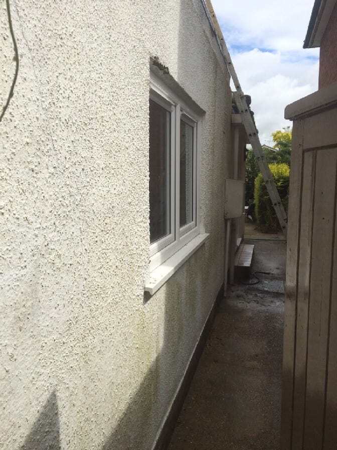 The side of the house was all green and mouldy and we had to powerwash all of this off before applying our weatherproof wall coatings.